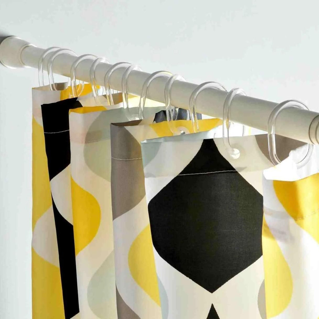 Curtains with geometric pattern hanging on a rod against a white background